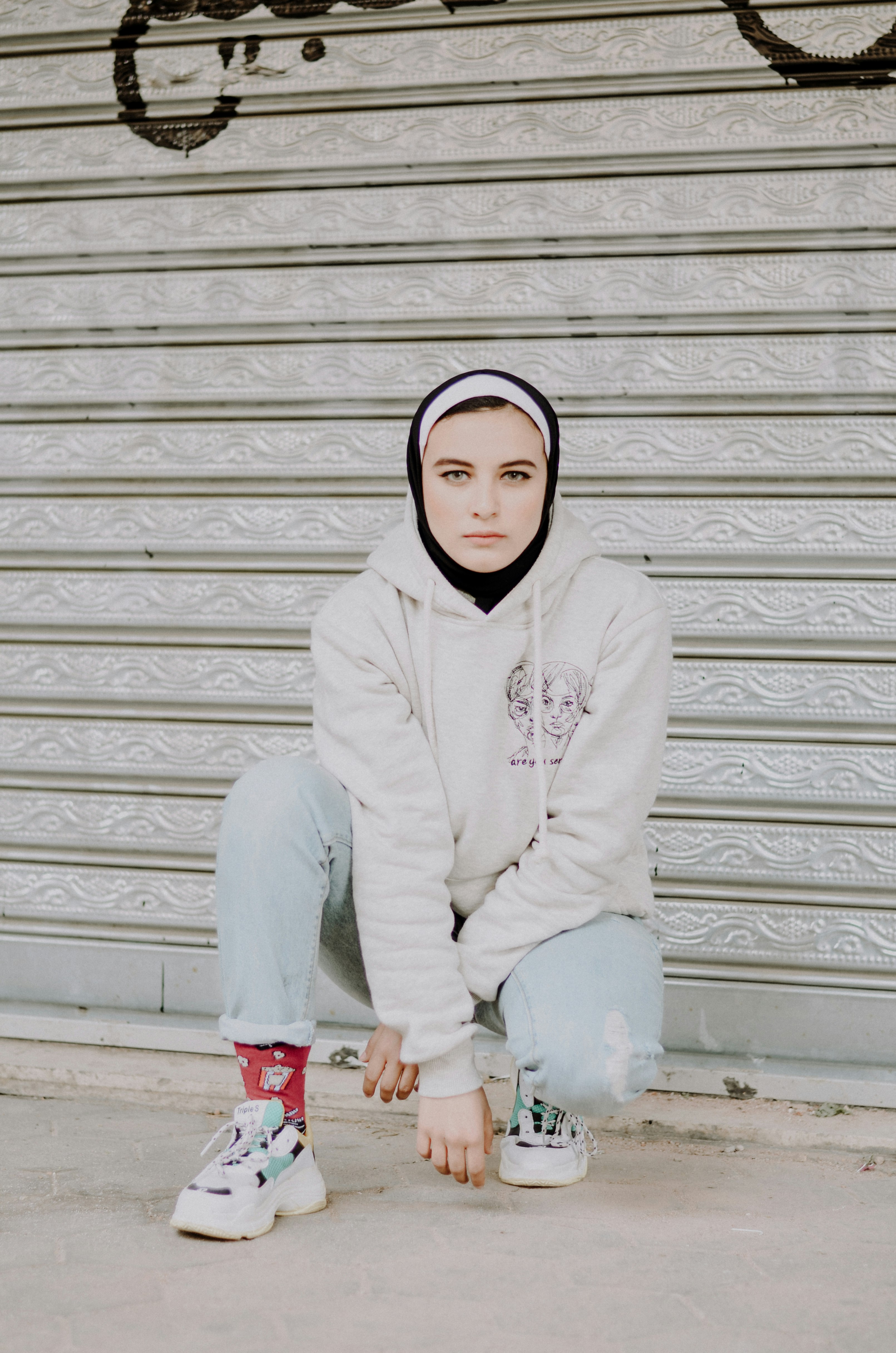 woman in white hoodie and blue denim jeans